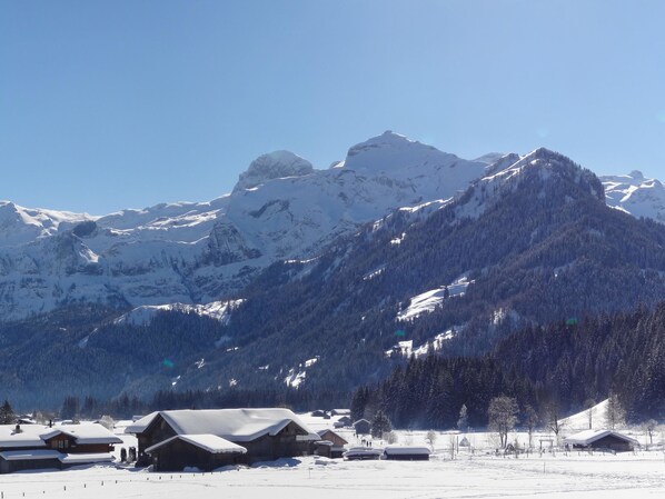 A snow-covered mountain landscape with wooden cabins and a clear sky. - Chalet Claudia by Interhome (Lenk)