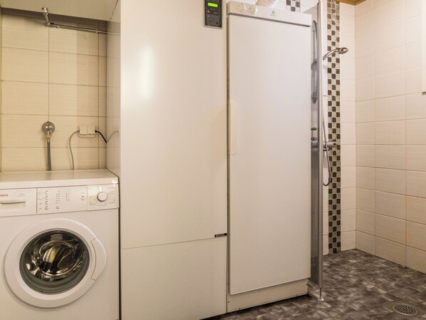 A compact laundry area with a Bosch washing machine and a white refrigerator.