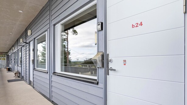 A building exterior with a row of windows and a door marked b24. - Snowflake b 24 by Interhome (Kuusamo)