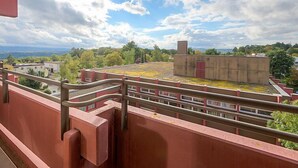 A balcony with a view of a building and surrounding greenery. - Birke (A504) by Interhome (Lahnstein (Koblenz))