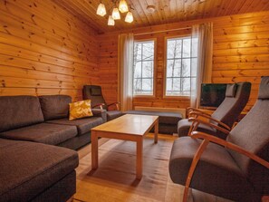 A log cabin interior with a sofa, armchairs, a coffee table, and a television. - Patrakka by Interhome (Hämeenlinna)