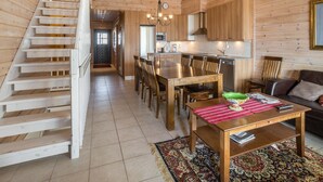 A wooden interior with a staircase, dining area, kitchen, and living room. - Ylläksen rinnemäki b by Interhome (Ylläsjärvi)