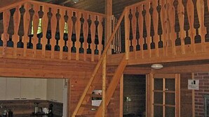 A wooden interior with a staircase and a kitchen area. - Mustikka by Interhome (Lohja)
