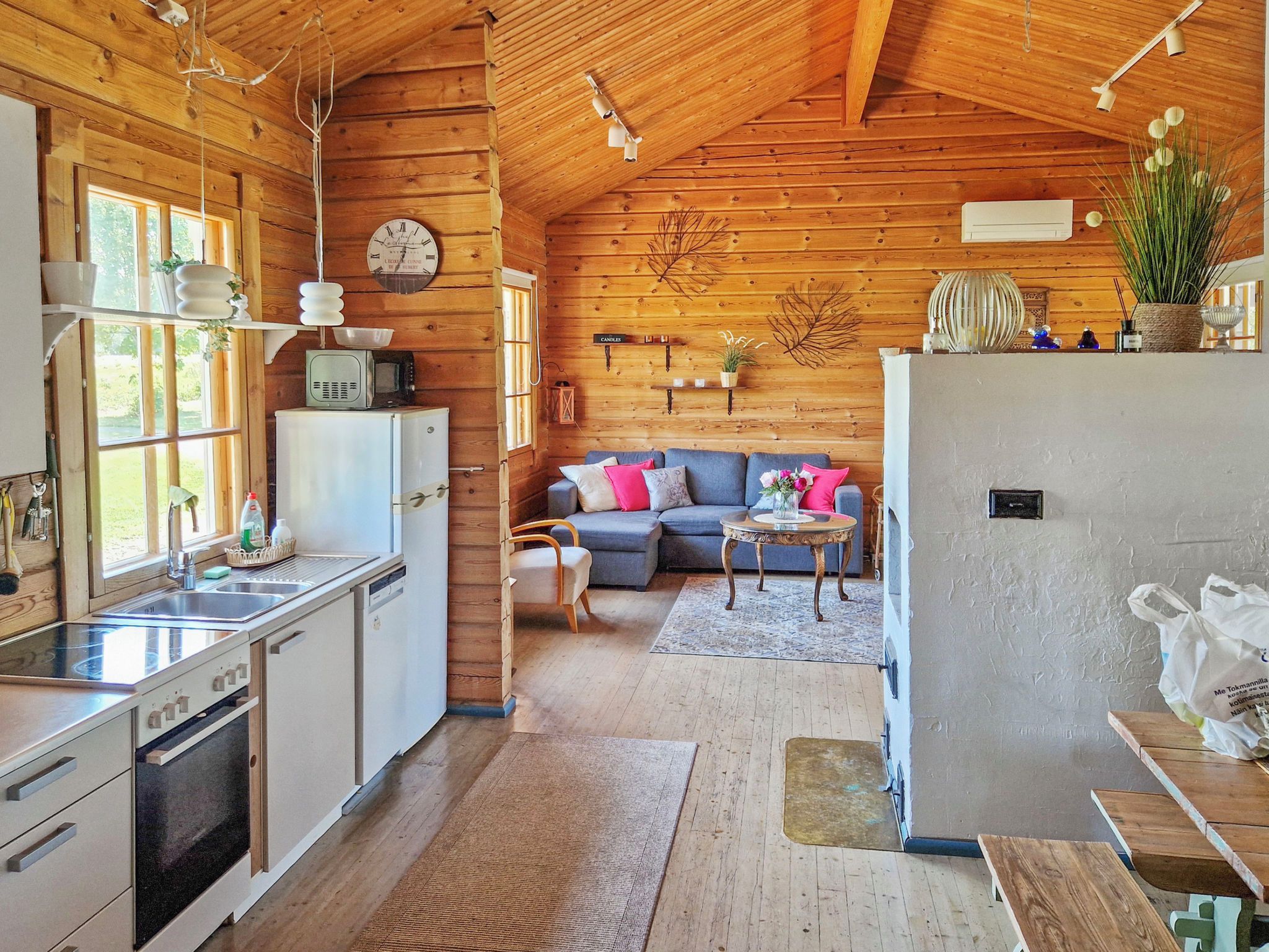 A cabin interior with a kitchen, dining area, and living room.