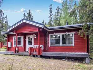 A red wooden cabin with a porch, two windows, and a chimney. - Joutilas by Interhome (Kuusamo)