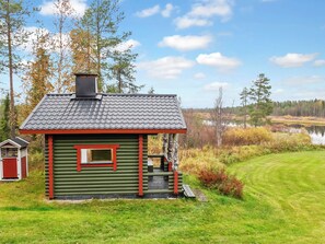 A small cabin with a sloped roof, a chimney, and a window.