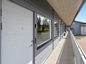 A corridor with a series of doors, each marked with a number.
