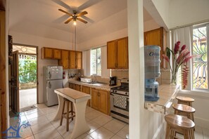 Enjoy cooking in this well-equipped kitchen with a central island and stools.