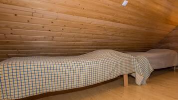 Simple, rustic cabin with two single beds and basic amenities.