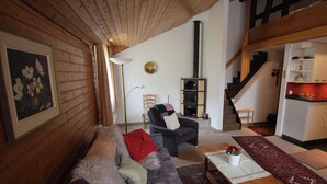 Una sala de estar acogedora con un sofá, una mesa de centro y una chimenea.