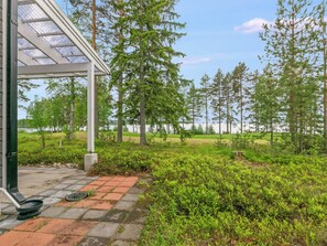 A covered outdoor area with a paved walkway leading to a building with a glass roof. - Paltamon golfhovi b by Interhome (Paltamo)