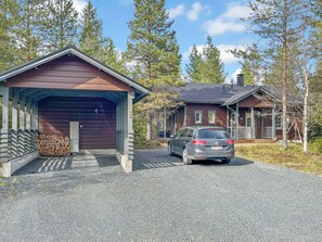 A two-story cabin with a gravel driveway and a parked car. - Lupporanta by Interhome (Kuusamo)