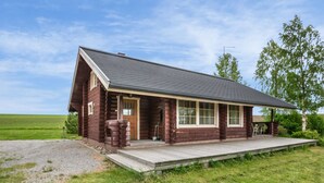 A log cabin with a porch, a front door, and a small deck. - Juusola by Interhome (Ikaalinen)