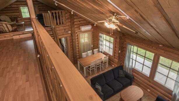 A log cabin interior with a dining area, sofa, and a ceiling fan. - Juusola by Interhome (Ikaalinen)