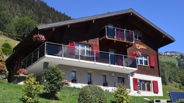 A two-story chalet with a balcony, surrounded by greenery and mountains. - Matten EG Süd by Interhome (Ried-Mörel)
