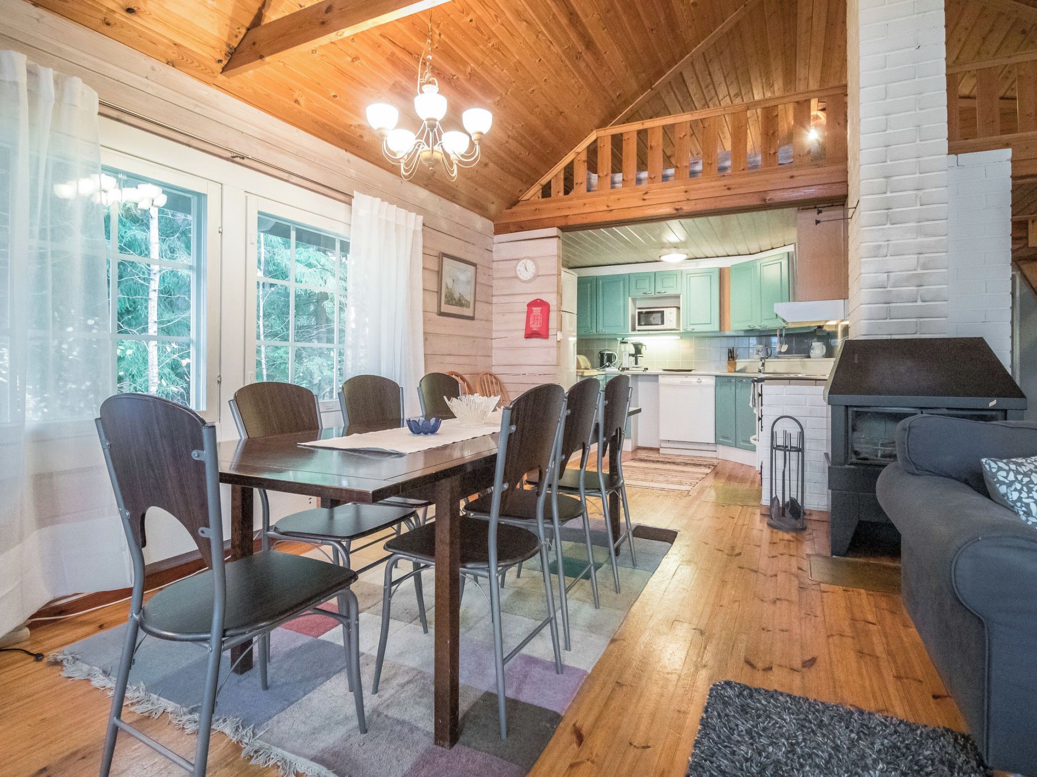 A cozy interior with a dining area, kitchen, and seating space.