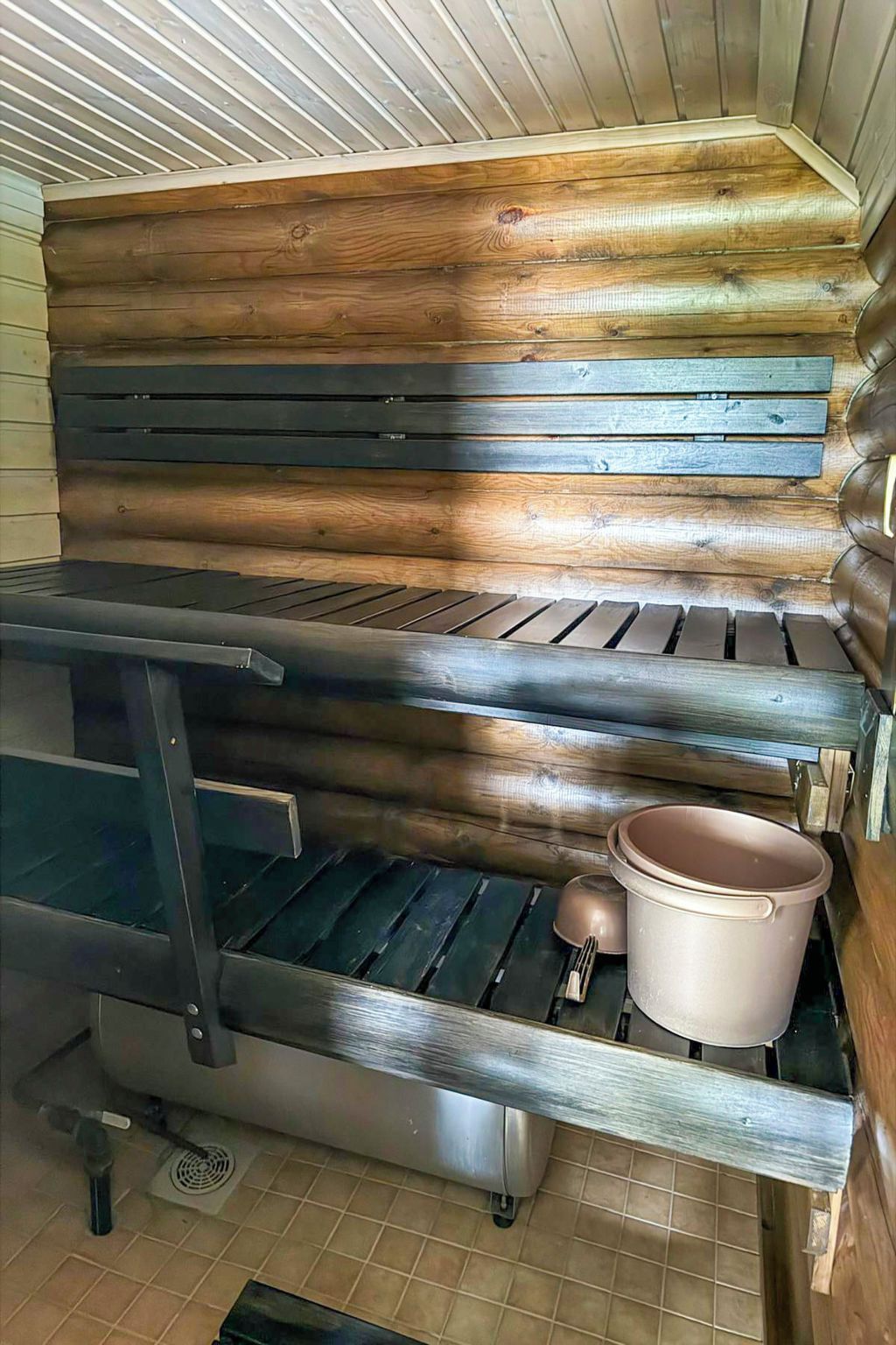 A kitchen with a built-in stove, a sink, and a pot on the counter.