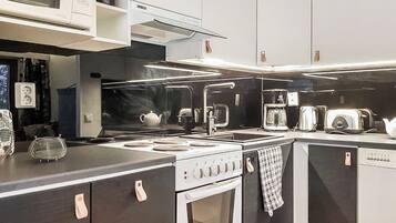 A modern kitchen with a stove, microwave, and toaster.