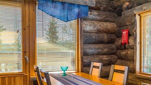 A wooden dining table with chairs, a blue placemat, and a glass bowl. - Rinnekieppi 2 by Interhome (Kuusamo)