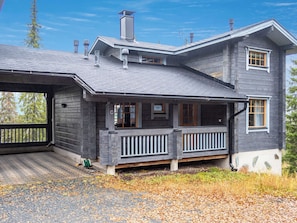 A two-story house with a covered porch and a garage.
