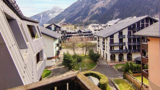 A mountain resort with traditional architecture, a central courtyard, and views of snow-capped mountains. - Le Grépon by Interhome (Chamonix)