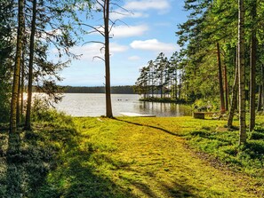 A natural landscape with a lake, surrounded by trees and grassy areas. - Aapeli iso by Interhome (Ähtäri)