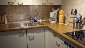 A kitchen with a sink, stove, and various appliances. - Neuschwändi 63 Appartement/Fewo 4-Bettwohnung by Interhome (Engelberg)