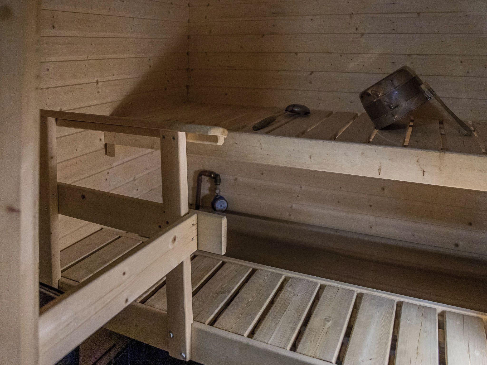 A bunk bed with a pull-out desk and a small shelf.