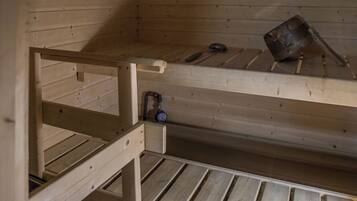 A bunk bed with a pull-out desk and a small shelf.