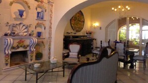 A cozy living room with a fireplace, a coffee table, and comfortable seating. - Casa Bacot - Four Bedroom Villa, Sleeps 8 (Canneto)