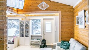 A cozy log cabin interior with a living room, a dining area, and a kitchen. - Lomasuvas by Interhome (Tuusniemi)