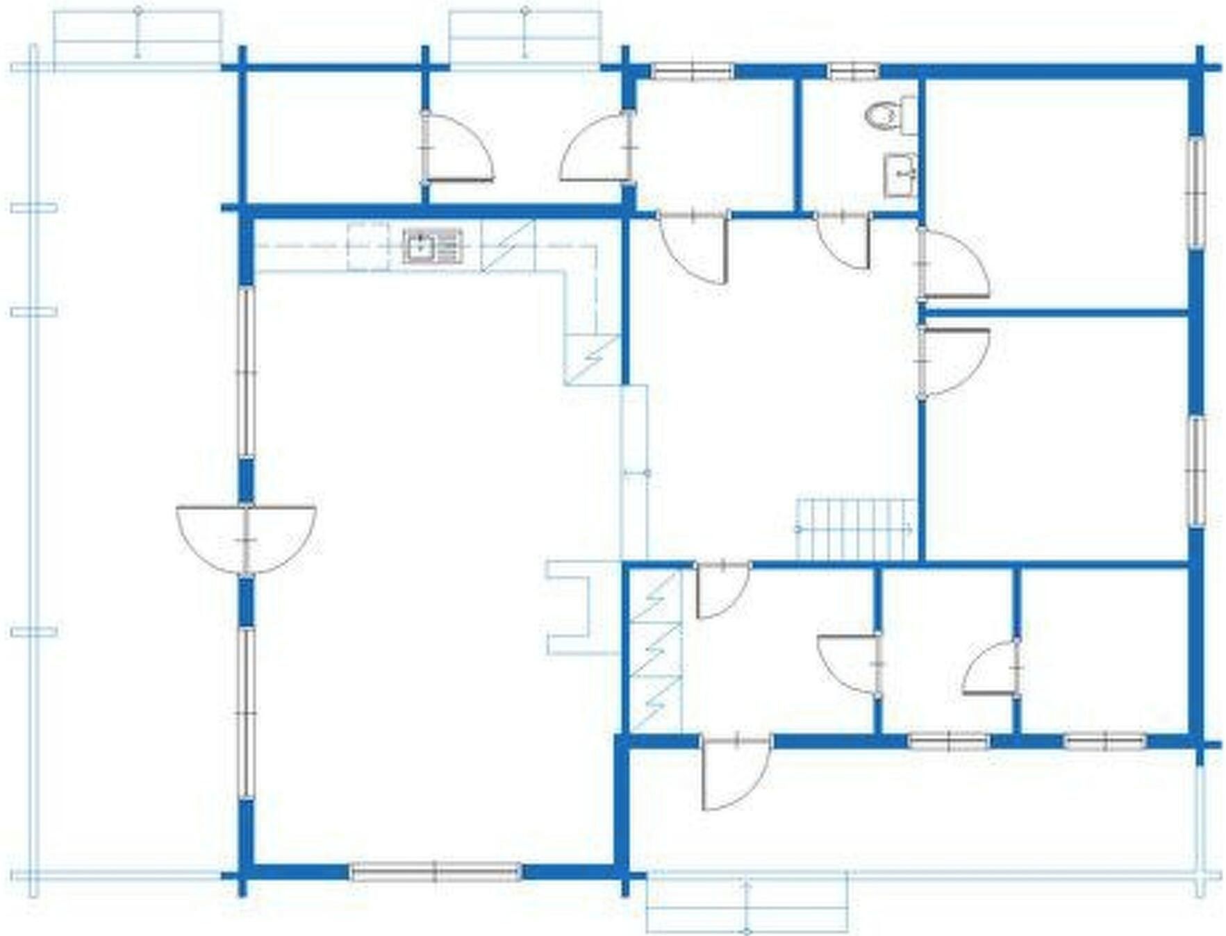 A floor plan with multiple rooms, including a large central area that could be a lobby or common space, several smaller rooms that could be bedrooms or offices, and a few bathrooms.