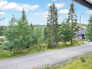 A rural road with trees and a building in the distance. - Luminalle by Interhome (Kuusamo)