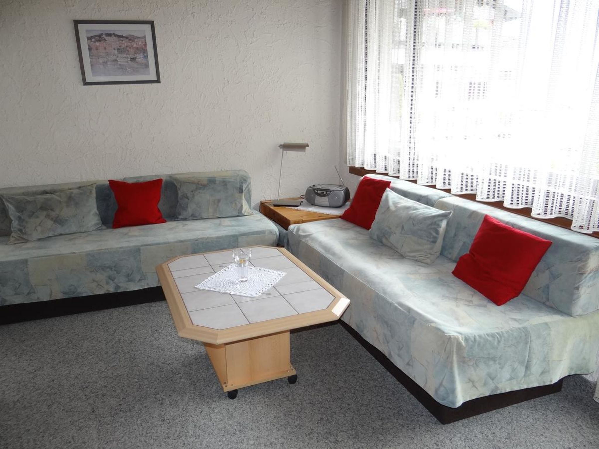 Una sala de estar con un sofá, una mesa de centro y una radio.