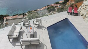 A rooftop pool area with a clear view of the sea, a seating arrangement, and a swimming pool. - Joan Margarit 84 B - Four Bedroom Villa, Sleeps 8 (Roses)