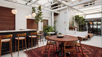 A modern interior with a bar area, seating, and a large window.