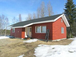 A red single-story house with a gabled roof, a front porch, and a small front yard. - Riitula by Interhome (Taivalkoski)