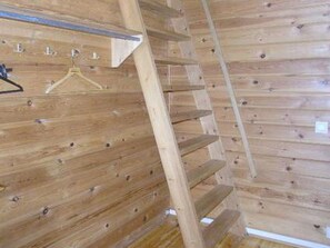 A wooden interior with a staircase and a metal hanger. - Riitula by Interhome (Taivalkoski)