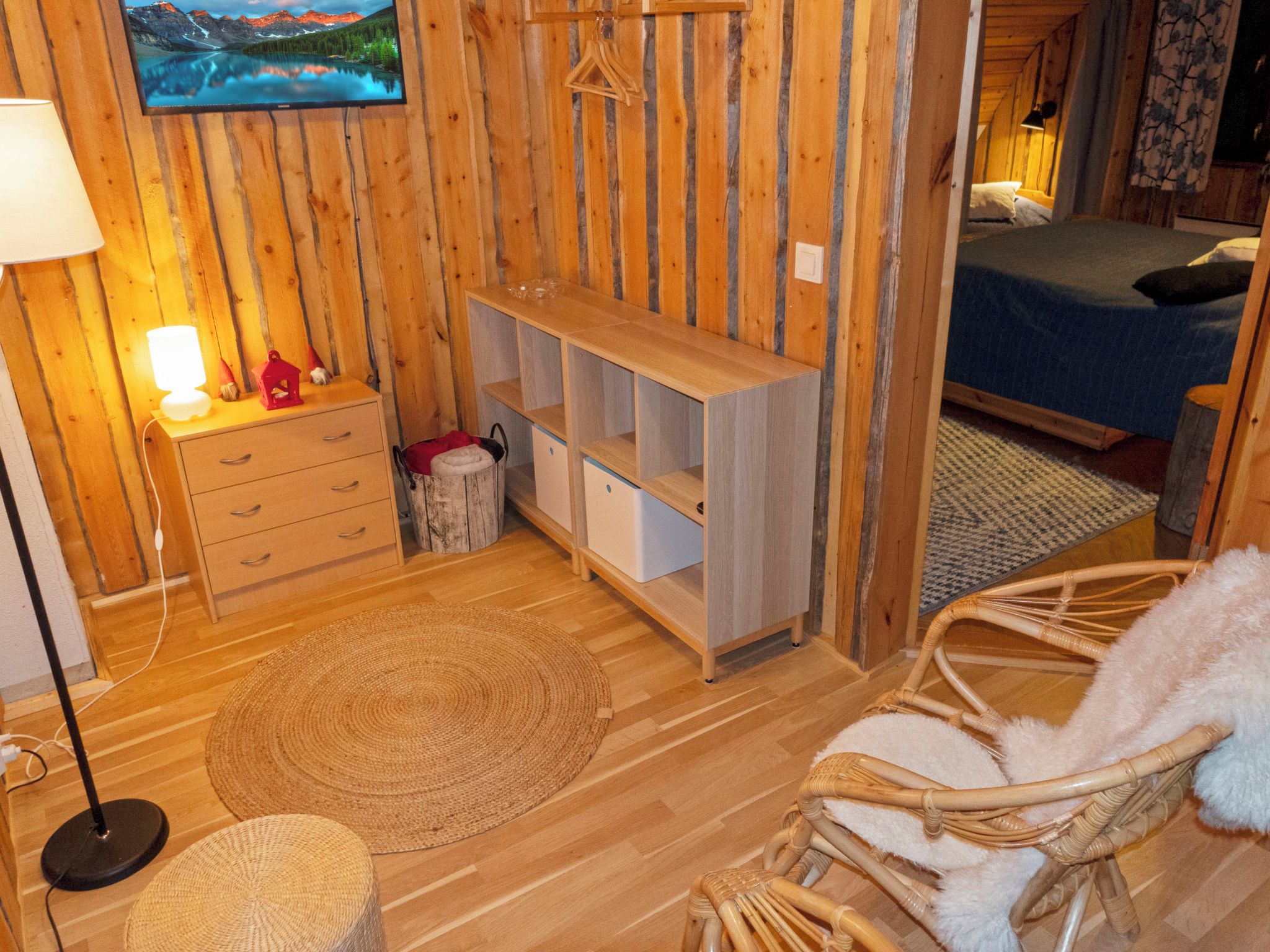 Une pièce confortable avec un lit, un bureau, une chaise et un téléviseur fixé au mur.