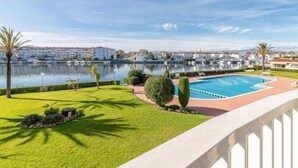 A pool area with a view of the water and buildings in the background. - Sant Maurici by Interhome (Empuriabrava)
