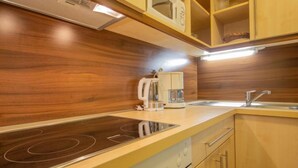 A kitchen with a built-in stovetop, a coffee maker, and a sink. - Apartment Alpin by Interhome (Sölden)