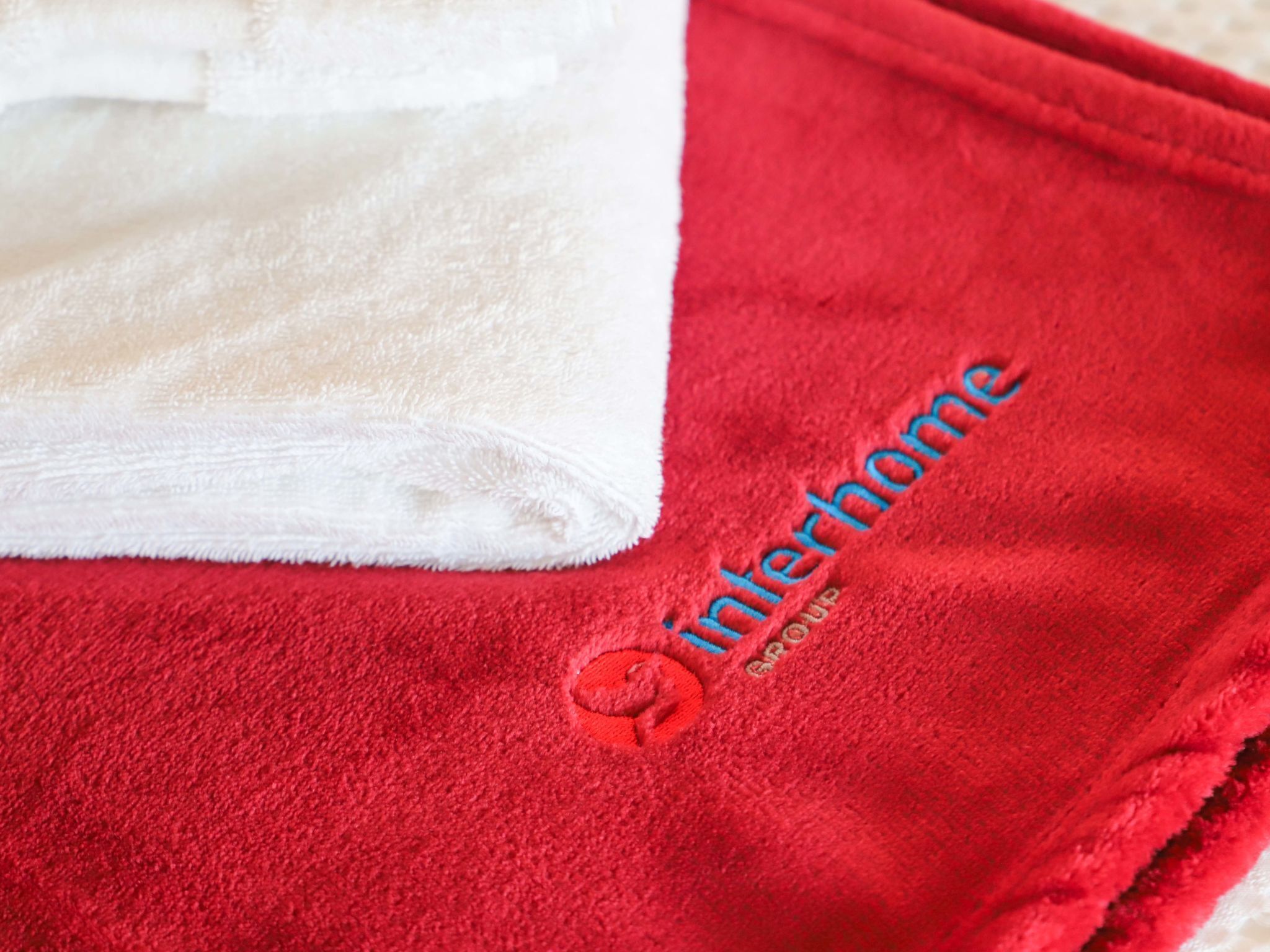 A red towel with a logo and the text "Interhome" on it.