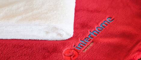 A red towel with a logo and the text "Interhome" on it.