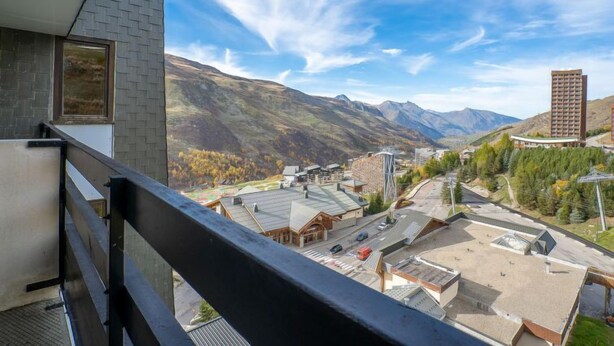 A balcony with a view of a town and mountains. - Chavière 832 by Interhome (Les Menuires)