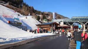 A ski resort with a ski lift, a covered waiting area, and a mountain backdrop. - Apartment Fabian by Interhome (Kaltenbach)