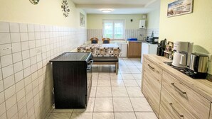 A compact kitchen with a central island, a sink, and a window. - Apartment Bless by Interhome (Schutterzell)