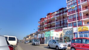 A multi-story building with balconies, a pizzeria, and a store named 'Gous'. - Le Grand Pavois by Interhome (Capbreton)