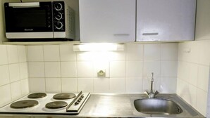 A kitchen with a stove, oven, microwave, and a sink. - Plein Ciel by Interhome (Carnac)