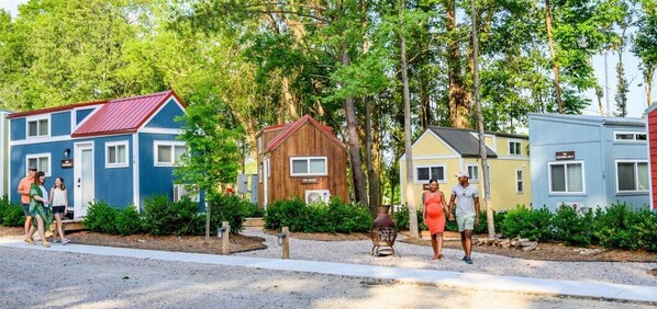 A row of colorful mobile homes with a gravel path in front. - River & Twine (Rocky Mount)