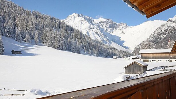 A snow-covered mountain landscape with a wooden cabin and a building with a sloped roof. - Obernberg by Interhome (Obernberg am Brenner)